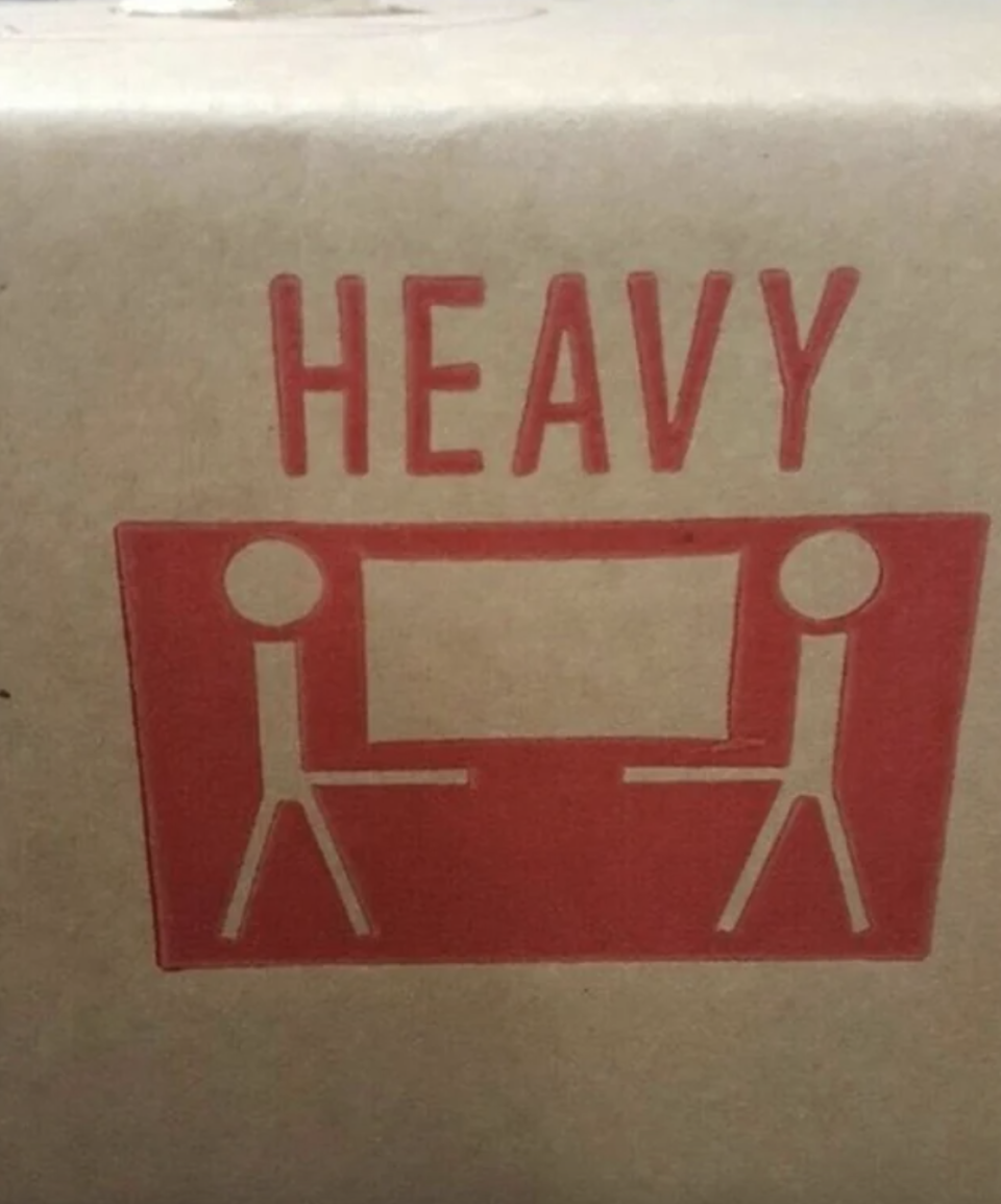 heavy sign and stick people carrying a box