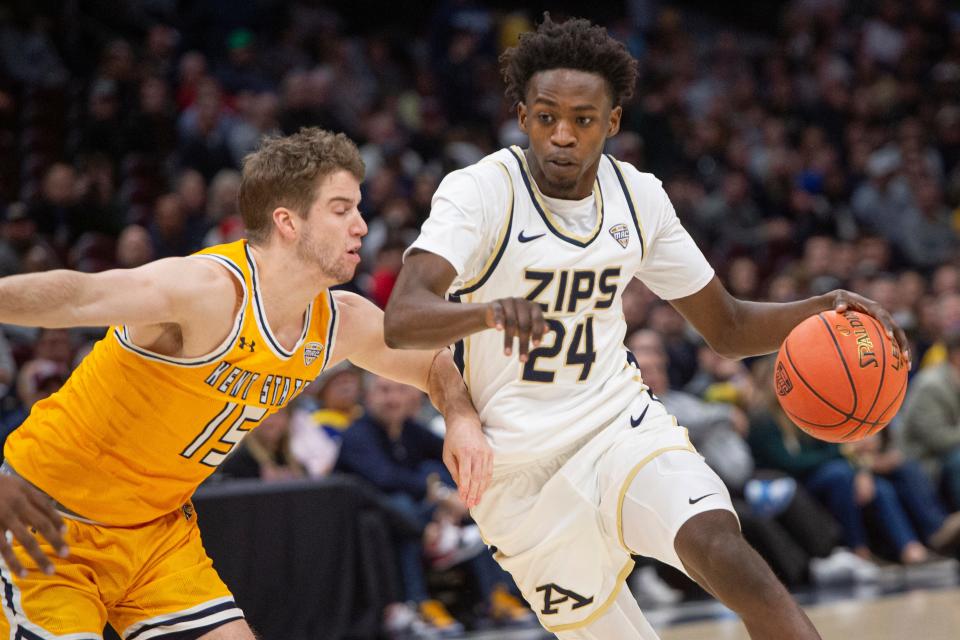 Akron's Ali Ali is defended by Kent State's Mike Bekelja in the first half of the Mid-American Conference Tournament championship game, Saturday, March 16, 2024, in Cleveland.