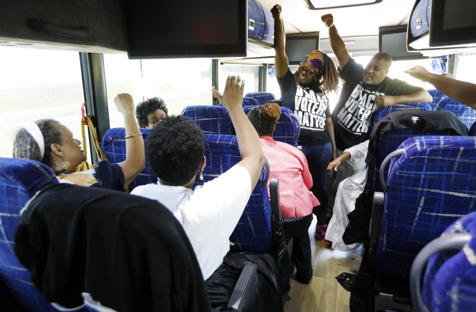 FILE - In this Aug. 24, 2018, file photo, Black Voters Matter Fund co-founders, LaTosha Brown, left, and Cliff Albright, right, lead Mississippi grassroots partners in some empowerment cheers aboard a bus tour to Greenville, Miss. Thousands of Black activists from across the U.S. will hold a virtual convention on Aug. 28, 2020, to produce a new political agenda that builds on the protests that followed George Floyd’s death. Albright, said the 2020 Black National Convention will deepen the solutions to systemic racism and create more alignment within the movement. (AP Photo/Rogelio V. Solis)