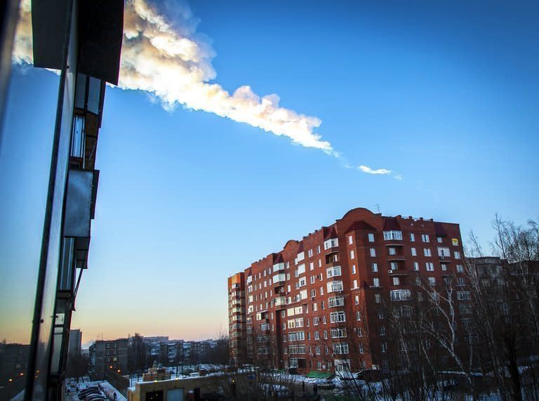 The trail of falling meteor is seen above a residential apartment block in Chelyabinsk, Russia, on February 15, 2013. A plunging meteor exploded with a blinding flash above central Russia, setting off a shockwave that shattered windows and hurt almost 1,000 people in an event unprecedented in modern times