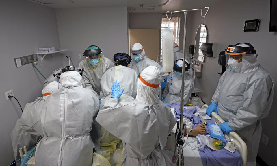 Dr. Joseph Varon, right, leads a team as they try to save the life of a patient unsuccessfully inside the Coronavirus Unit at United Memorial Medical Center, Monday, July 6, 2020, in Houston. Hospitalizations due to COVID-19 in the second-largest state in the U.S. have more than doubled in the last two weeks. (AP Photo/David J. Phillip)