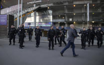 FILE - Police officers guard the Stade de France prior the Champions League final soccer match between Liverpool and Real Madrid, in Saint Denis near Paris, Saturday, May 28, 2022. UEFA-appointed investigators have held European soccer's ruling body mostly responsible for chaotic security failures at the Champions League final in Paris that put the lives of Liverpool and Real Madrid fans at risk, the investigation panel wrote in a 220-page document published Monday, Feb. 13, 2023. (AP Photo/Christophe Ena, File)