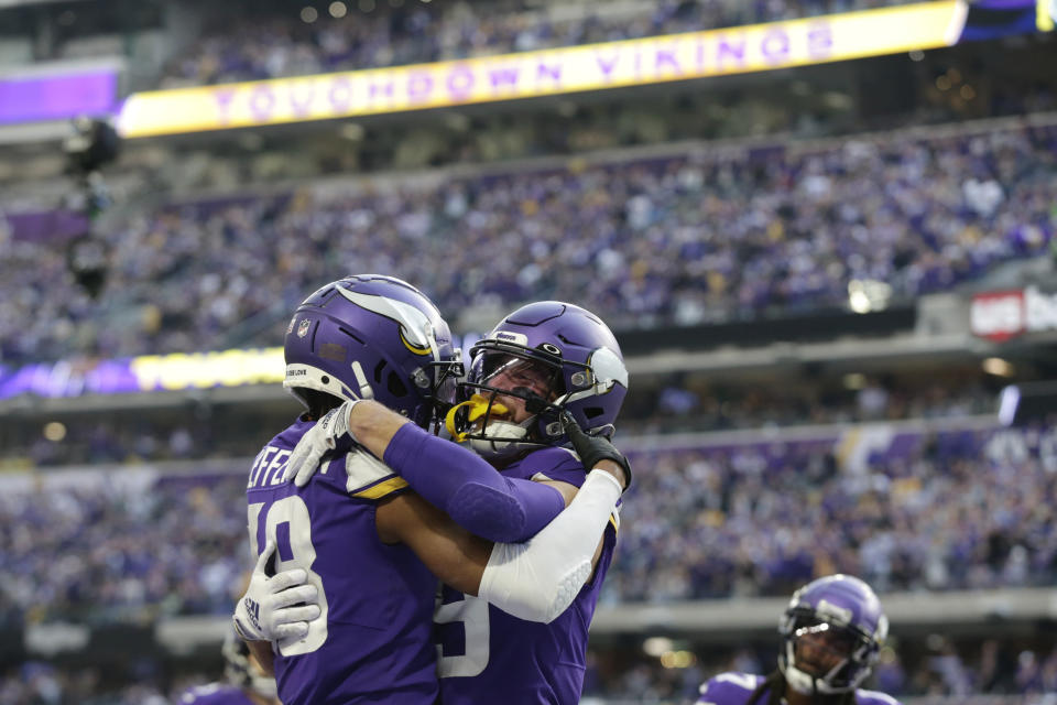 Minnesota Vikings wide receiver Justin Jefferson, left, celebrates with wide receiver Adam Thielen, right, after catching a 10-yard touchdown pass during the second half of an NFL football game against the New York Jets, Sunday, Dec. 4, 2022, in Minneapolis. (AP Photo/Andy Clayton-King)