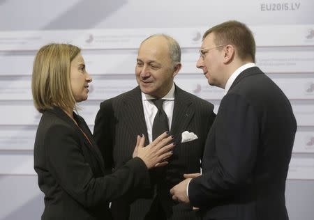 Latvia's Minister of Foreign Affairs Edgars Rinkevics (R) and France's Minister of Foreign Affairs Laurent Fabius (C) listen to European Union Foreign Policy Chief Federica Mogherini during the informal European Union Ministers of Foreign Affairs meeting (Gymnich) in Riga March 6, 2015. REUTERS/Ints Kalnins