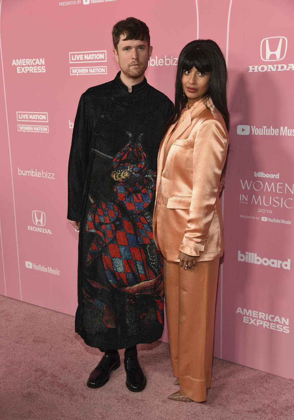 James Blake, left, and Jameela Jamil arrive at Billboard's Women in Music at the Hollywood Palladium on Thursday, Dec. 12, 2019, in Los Angeles. (AP Photo/Chris Pizzello)