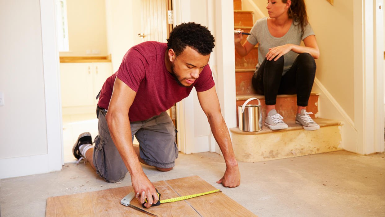 Man and woman renovating a home