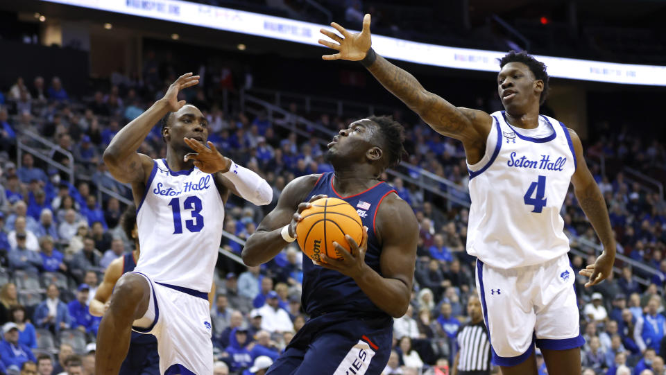 UConn forward Adama Sanogo drives to the basket against Seton Hall forwards KC Ndefo (13) and Tyrese Samuel (4) during the first half of an NCAA college basketball game in Newark, N.J., Wednesday, Jan. 18, 2023. (AP Photo/Noah K. Murray)