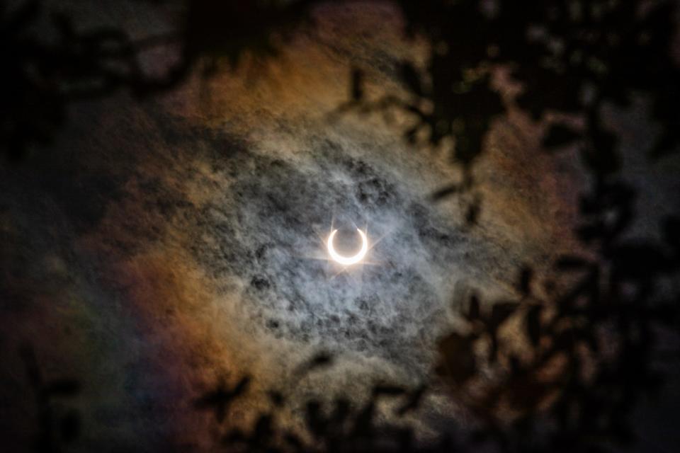 The moon moves in front of the sun creating a shadow during an annular solar eclipse at Lake Corpus Christi State Park on Saturday, Oct. 14, 2023, in Mathis, Texas.