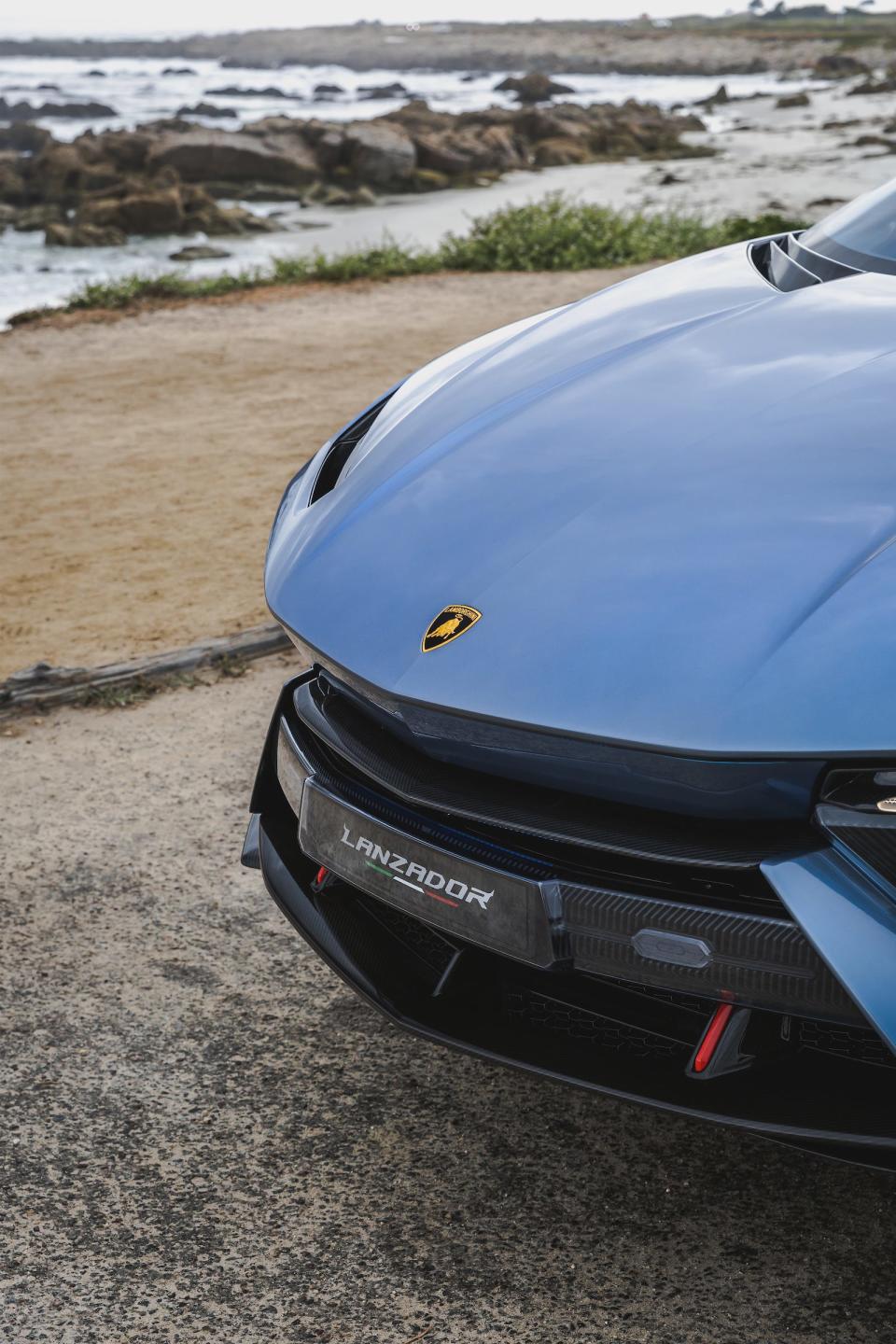 The Lamborghini Lanzador's nose, with a beach in the background. 