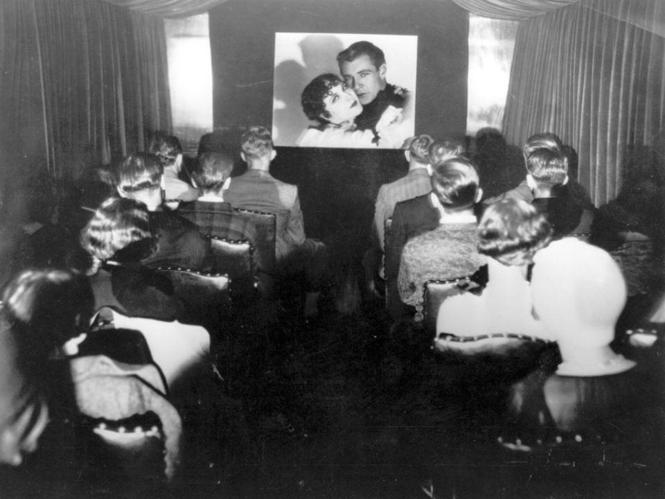 Passengers watch a film starring Gary Cooper aboard a US railway train in 1925.