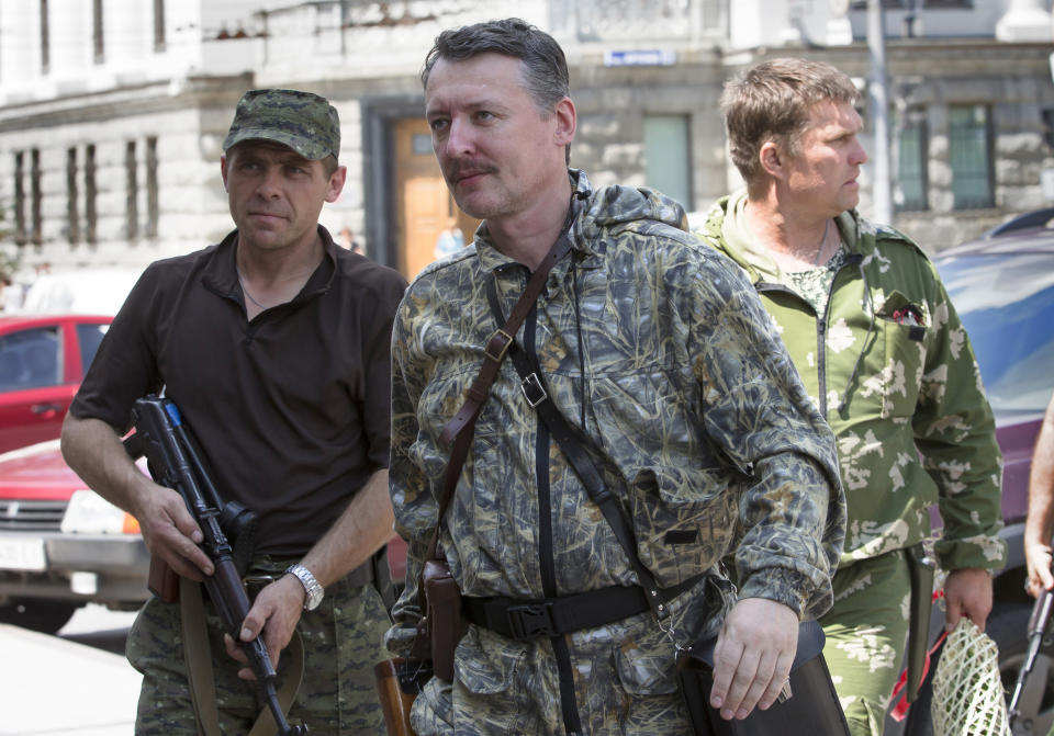 FILE - Igor Girkin also known as Igor Strelkov, a pro-Russian commander, center, arrives for the wedding of platoon commander Arsen Pavlov and Elena Kolenkina in the city of Donetsk, eastern Ukraine, Friday, July 11, 2014. Strelkov, a high-profile Russian hard-line official who harshly criticized President Vladimir Putin over fighting in Ukraine was detained Friday, July 21, 2023 on charges of extremism, a signal the Kremlin has toughened its approach to hawkish critics after last month's abortive mutiny by the Wagner mercenary company. (AP Photo/Dmitry Lovetsky, File)