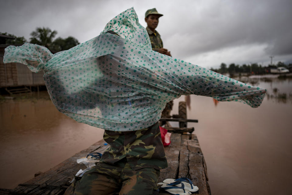 <p>Soldiers make their way to affected villages after flash floods engulfed these several villages, on July 26, 2018 in Attepeu, southeastern Laos. (Photo: Jes Aznar/Getty Images) </p>