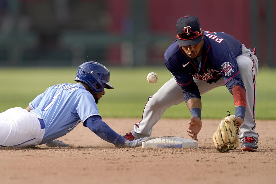 Kansas City Royals' Jarrod Dyson beats the tag by Minnesota Twins second baseman Jorge Polanco as he dove back to second on a ground out hit into by Jorge Soler during the ninth inning of a baseball game Saturday, June 5, 2021, in Kansas City, Mo. The Twins won 5-4. (AP Photo/Charlie Riedel)