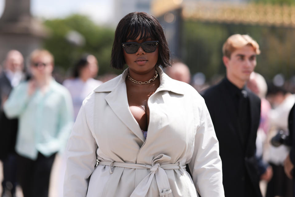 Precious Lee in a beige trenchcoat and a strictly-business chin-length bob at the Dior Homme Menswear spring-summer 2024 fashion show during Paris Fashion Week.