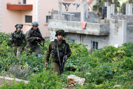 Israeli forces search for a Palestinian gunman in Beit Fourik, in the occupied West Bank March 17, 2019. REUTERS/Mohamad Torokman