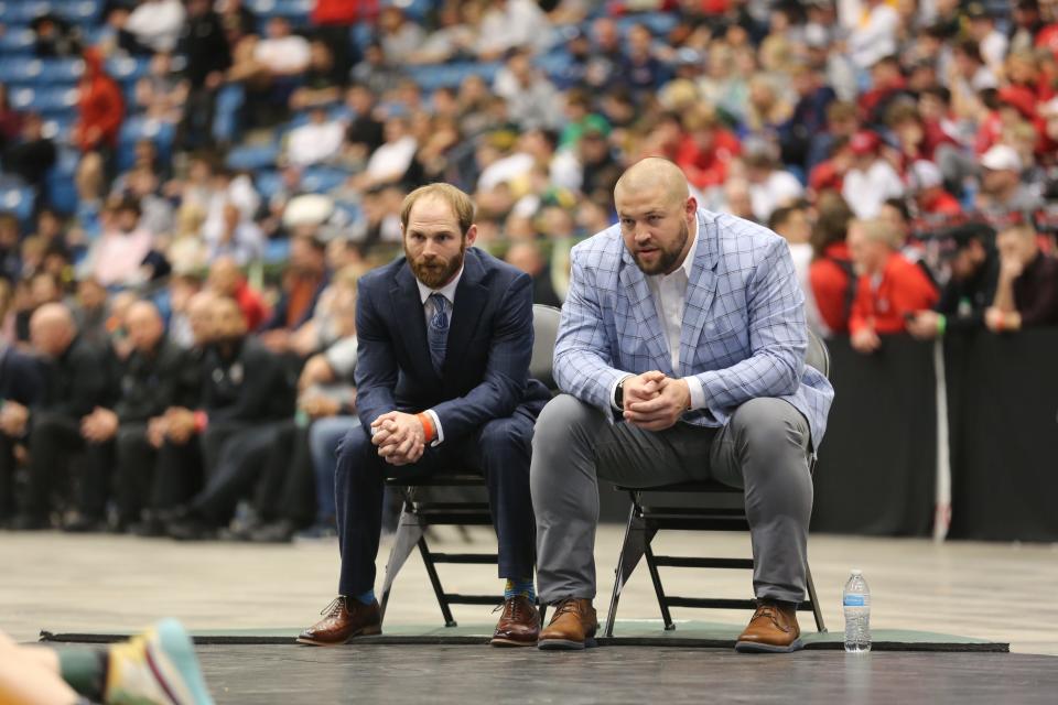 Washburn Rural coach Josh Hogan (left) and assistant coach Duane Zlatnik (right) watch Easton Broxterman wrestle for a state title on Saturday at Hartman Arena.