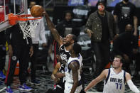 Los Angeles Clippers forward Kawhi Leonard (2) dunks against Dallas Mavericks forward Dorian Finney-Smith (10) during the first quarter of Game 7 of an NBA basketball first-round playoff series Sunday, June 6, 2021, in Los Angeles, Calif. Mavericks guard Luka Doncic (77) looks on. (AP Photo/Ashley Landis)