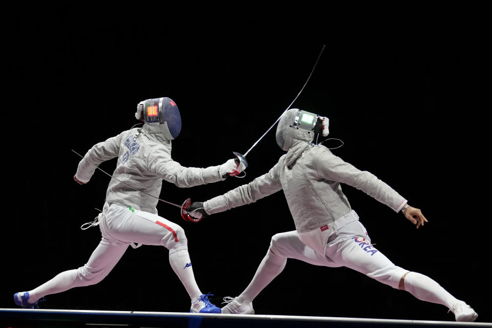 Aldo Montano of Italy, left, and Oh Sanguk of South Korea compete in the men's Sabre team medal at the 2020 Summer Olympics, Wednesday, July 28, 2021, in Chiba, Japan. (AP Photo/Andrew Medichini)