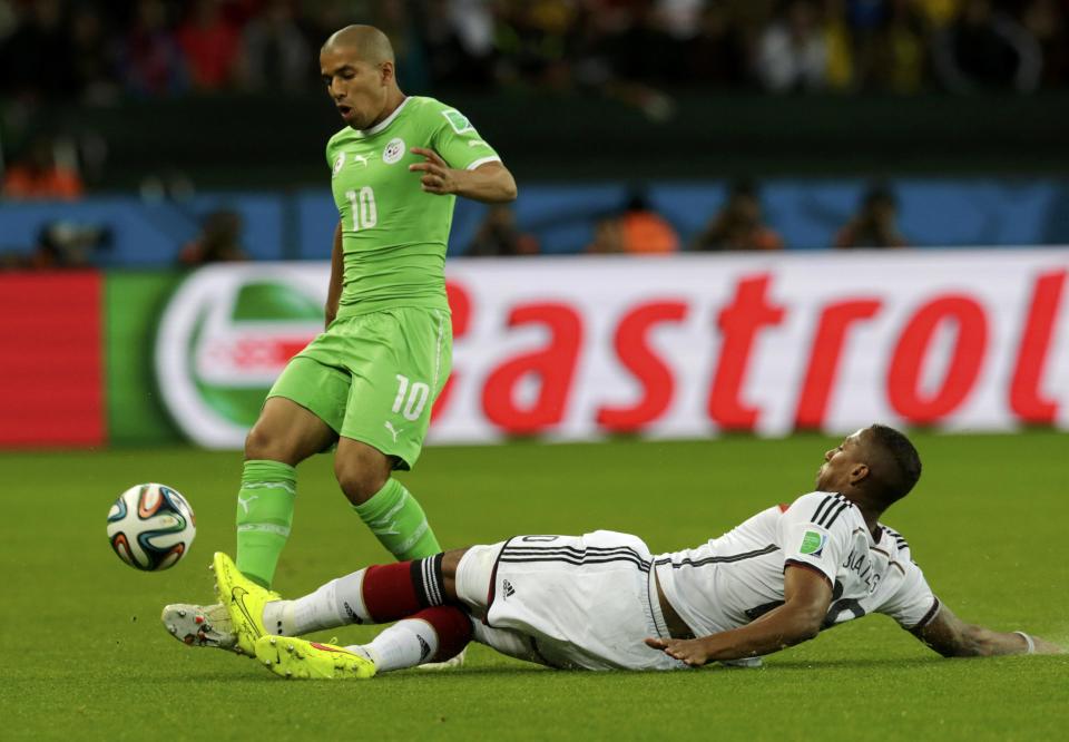 Algeria's Sofiane Feghouli and Germany's Jerome Boateng fight for the ball during their 2014 World Cup round of 16 game at the Beira Rio stadium in Porto Alegre June 30, 2014. REUTERS/Henry Romero