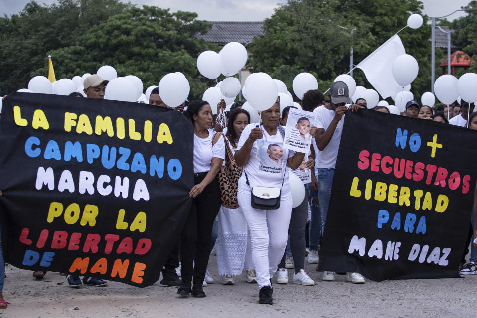 People march demanding the release of the father of Liverpool striker, Luis Diaz, in Barrancas, La Guajira department, Colombia, Tuesday, Oct. 31, 2023. The parents of the 26-year-old Diaz were reportedly kidnapped as they drove to their home. Cilenis Marulanda, mother of the Colombian soccer player, was rescued by police in Barrancas, Colombia’s President Gustavo Petro said. (AP Photo/Leo Carrillo)