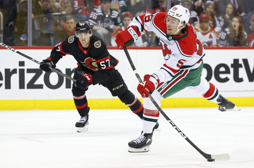 New Jersey Devils left wing Erik Haula (56) shoots the puck against Ottawa Senators center Shane Pinto (57) during the second period of an NHL hockey game, Saturday, March 25, 2023, in Newark, N.J. (AP Photo/Noah K. Murray)