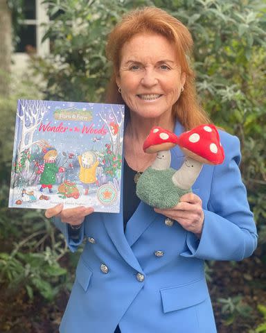 <p>Sarah Ferguson/Instagram</p> Sarah Ferguson takes a photo with her children's book 'Flora and Fern: Wonder in the Woods'