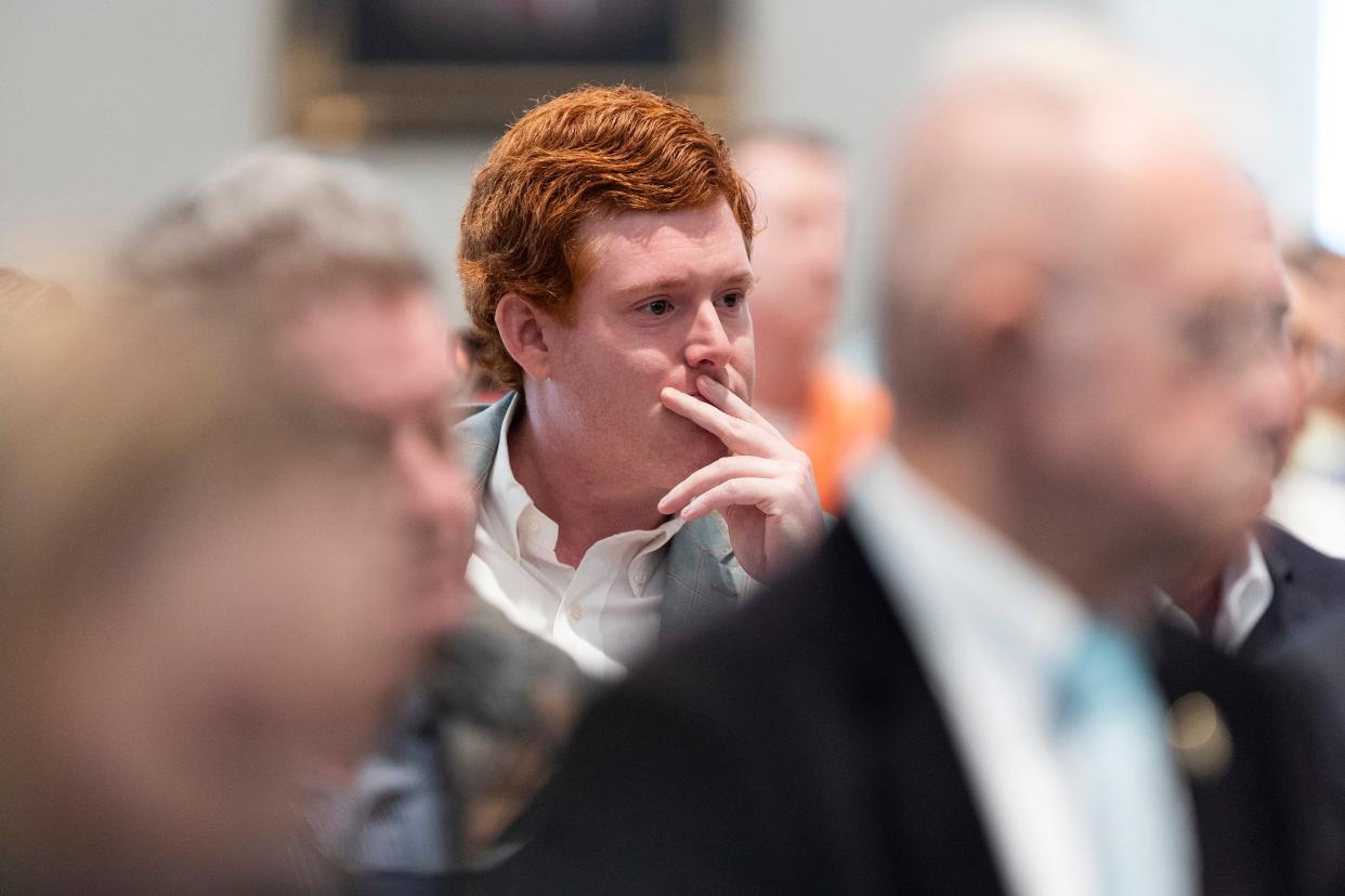 Buster Murdaugh listens as his father Alex Murdaugh testifies in his own trial (AP)