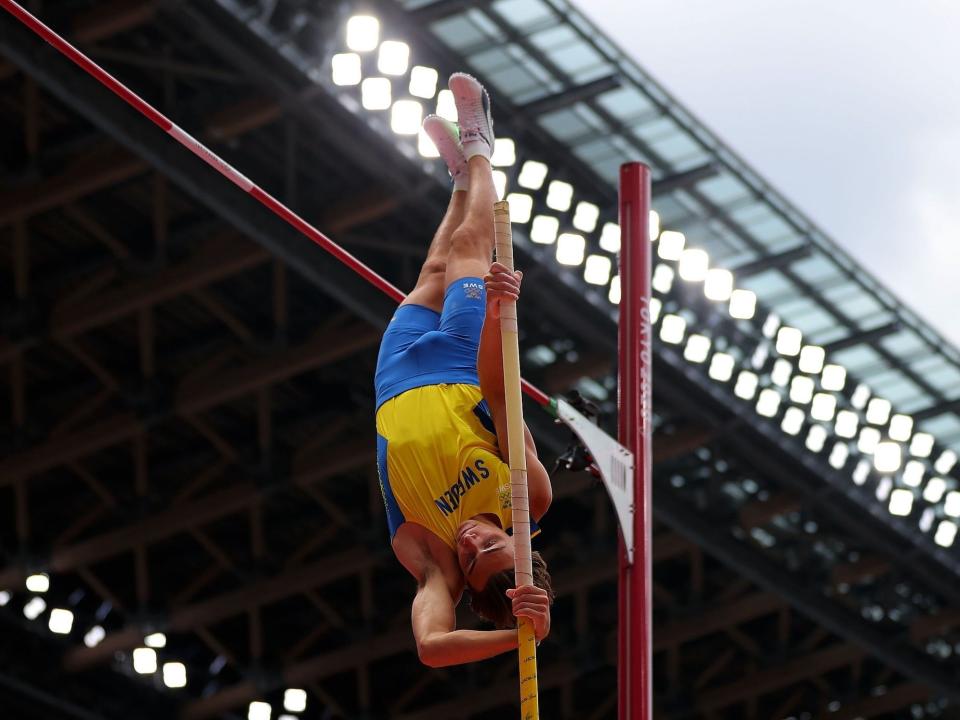 Armand Duplantis of Sweden pushes off the pole at the pole vault in the Tokyo Olympics.