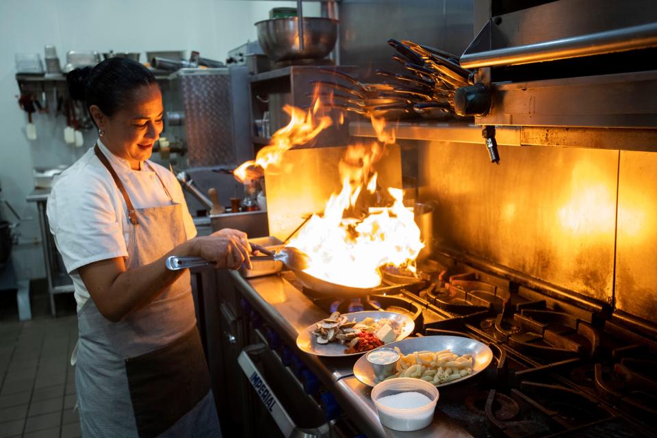 The Fort Steakhouse Executive Chef Angela Acosta cooks some of the menu items for the reimagined restaurant on Thursday, Dec. 2, 2021, on Second Street in Fort Pierce. The restaurant, which originally opened as The Braford steakhouse in March 2018, will return Dec. 9 after shuttering in April because of a staff shortage. "I want to bring in big, bold flavors here... and Instagrammable moments that people are looking for," she said.