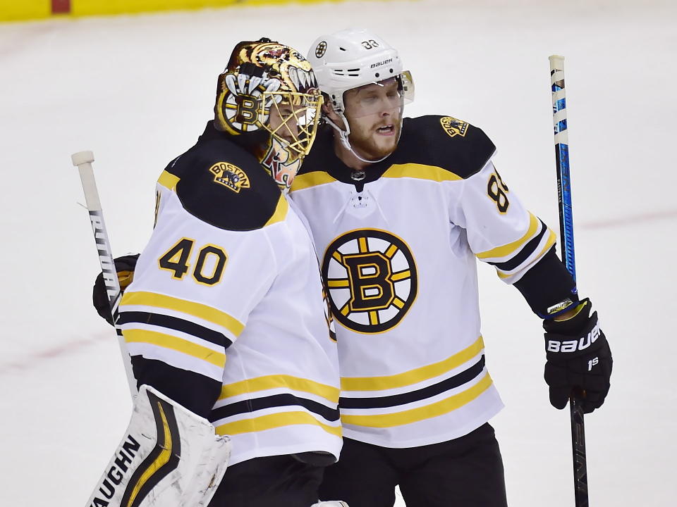 Boston Bruins goaltender Tuukka Rask (40) and teammate David Pastrnak (88) celebrate defeating the Toronto Maple Leafs after Game 4 of an NHL hockey first-round playoff series Wednesday, April 17, 2019, in Toronto. (Frank Gunn/The Canadian Press via AP)