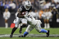 Los Angeles Chargers middle linebacker Kenneth Murray (9) tackles Las Vegas Raiders wide receiver Bryan Edwards (89) after a catch during the first half of an NFL football game, Sunday, Jan. 9, 2022, in Las Vegas. (AP Photo/Ellen Schmidt)