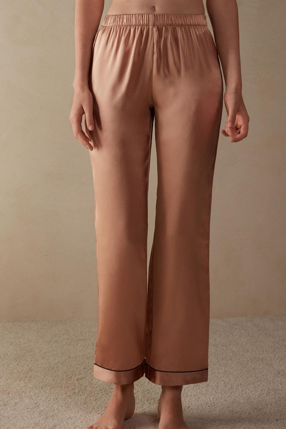 model wearing brown silk pajama pants