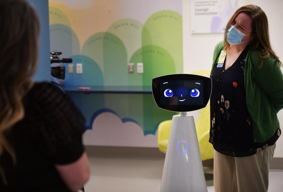 Kendra Frederick, manager of Child Life at Umass Memorial Health, University Campus interacts with “Robin” Tuesday, the new pediatric robot that interacts with kids. It is the third hospital in the country to have the human-assisted robot.