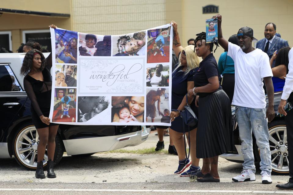 A memory banner is held up by family during the funeral services for 29-year-old Jerrald Gallion on Saturday at St. Paul Missionary Baptist Church of Jacksonville. Gallion was one of three Black victims killed in the Aug. 26 shooting at a Dollar General store near Edward Waters University.