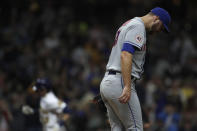 New York Mets' Tylor Megill, right, reacts after giving up a solo home run to Milwaukee Brewers' Christian Yelich during the third inning of a baseball game, Friday, Sept. 24, 2021, in Milwaukee. (AP Photo/Aaron Gash)