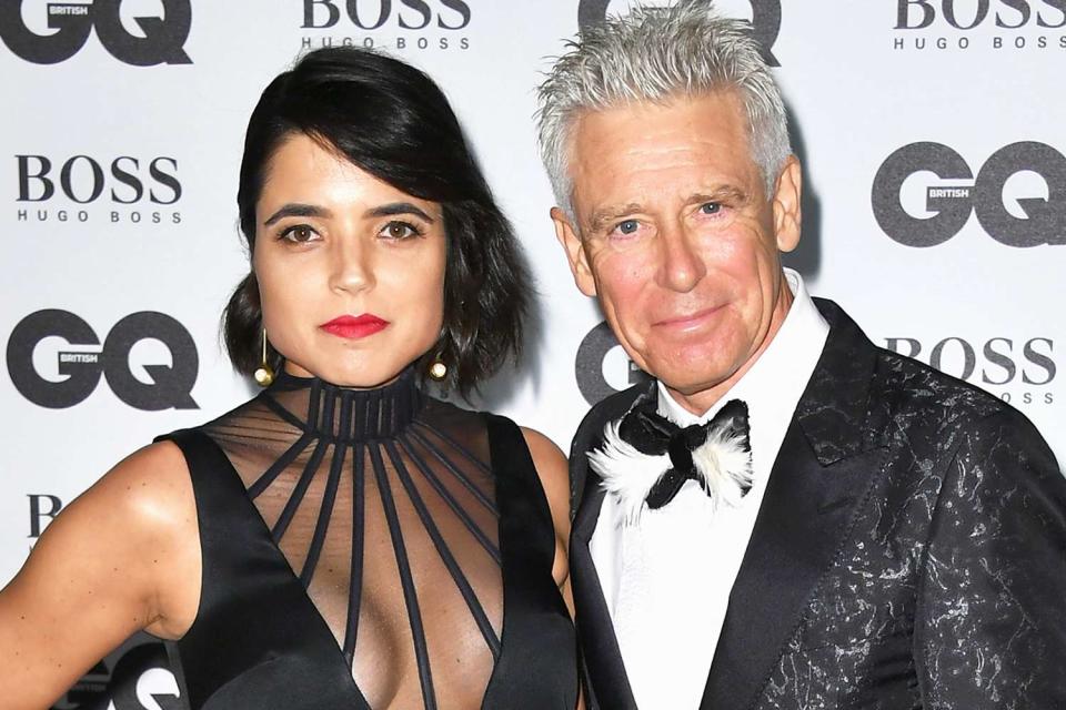 <p>Gareth Cattermole/Getty</p> Mariana Teixeira de Carvalho and Adam Clayton in London in September 2016