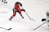 Chicago Blackhawks left wing Alex DeBrincat (12) shoots the puck for a goal against the Dallas Stars during the second period of an NHL hockey game Tuesday, April 6, 2021, in Chicago. (AP Photo/Jeff Haynes)