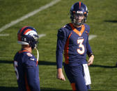 Denver Broncos quarterback Drew Lock, right, confers with quarterback Riley Neal during NFL football practice Wednesday, Nov. 25, 2020, in Englewood, Colo. (AP Photo/David Zalubowski)