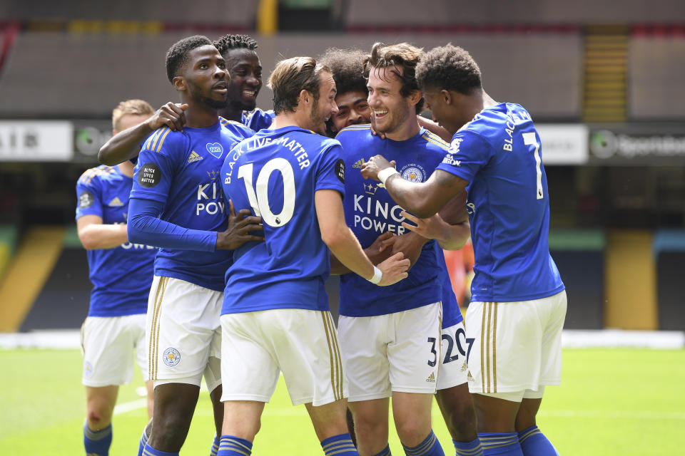 Leicester's Ben Chilwell, center right, celebrates after scoring his side's opening goal during the English Premier League soccer match between Watford and Leicester City at the Vicarage Road Stadium in Watford, England, Saturday, June 20, 2020. (Andy Rain/Pool via AP)