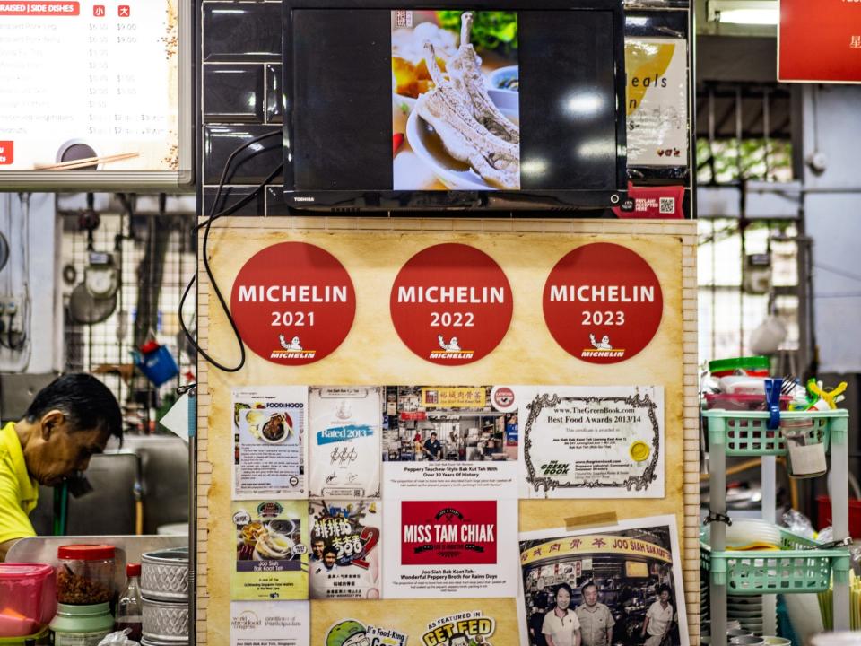 A stall with three Michelin awards displayed.