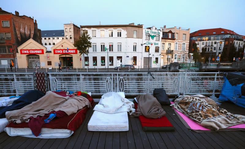 Asylum seekers sleep on a street in central Brussels