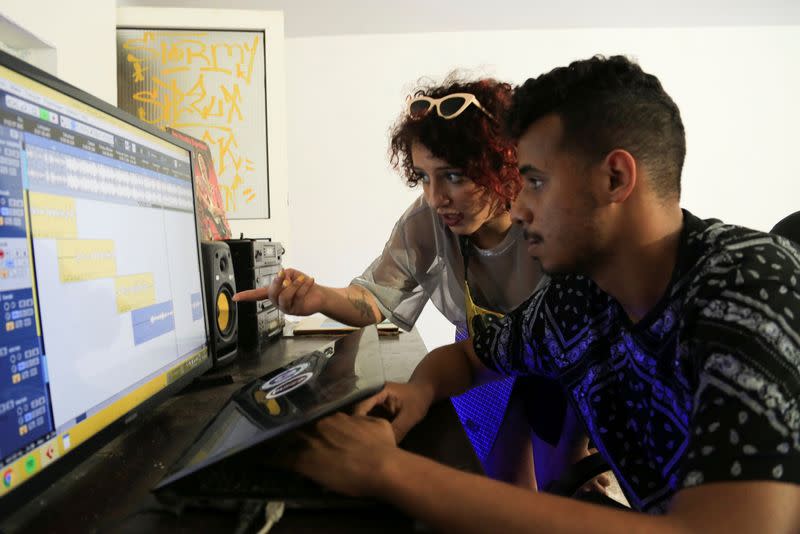 Moroccan rapper Houda Abouz, 24, known by her stage name "Khtek", works on a song with her composer inside a studio in Rabat