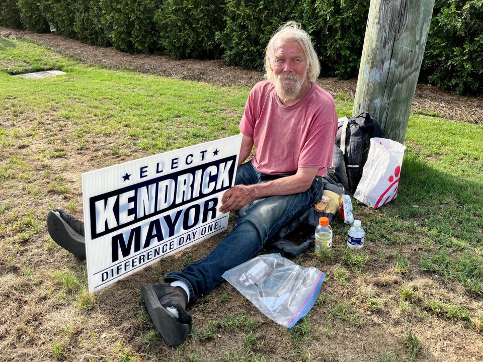 Steve Waters enjoys some snacks as he campaigns for mayoral candidate Steven Kendrick outside Providence Baptist Church on Wrightsboro Road in Augusta, GA.