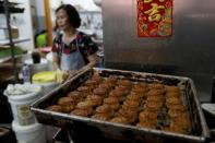 An employee walks past mooncakes with anti-extradition bill slogans, at Wah Yee Tang Bakery in Hong Kong