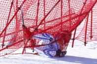 Romania's Ioan Valeriu Achiriloaie crashes into the safety nets during the downhill run of the men's alpine skiing super combined event at the 2014 Sochi Winter Olympics at the Rosa Khutor Alpine Center February 14, 2014. REUTERS/Ruben Sprich (RUSSIA - Tags: SPORT SKIING OLYMPICS TPX IMAGES OF THE DAY)