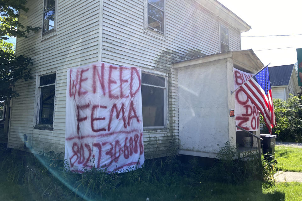 A sign asking for help from FEMA, Federal Emergency Management Agency, hangs on a flood-ravaged home in Johnson, Vt. on Wednesday, Aug. 23, 2023. With Vermont’s already tight housing market and cold weather fast approaching, some flood victims who lost homes don’t yet know where they’ll live. (AP Photo/Lisa Rathke)