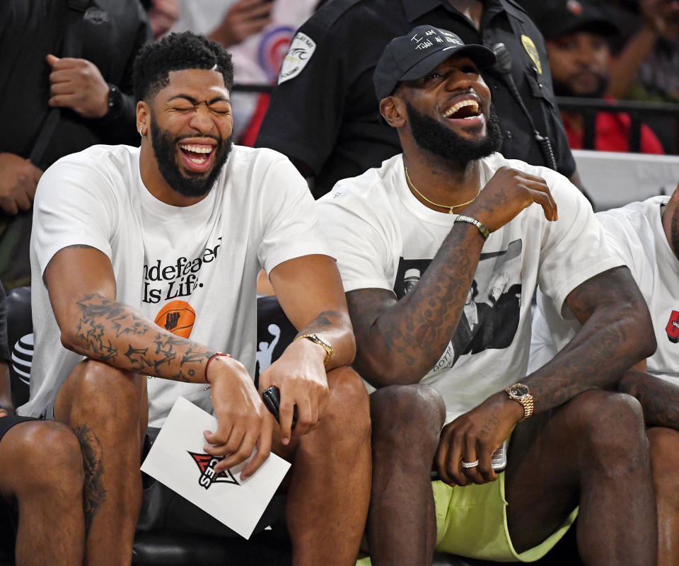 LAS VEGAS, NEVADA - SEPTEMBER 24:  Anthony Davis (L) and LeBron James of the Los Angeles Lakers laugh while attending Game Four of the 2019 WNBA Playoff semifinals between the Washington Mystics and the Las Vegas Aces at the Mandalay Bay Events Center on September 24, 2019 in Las Vegas, Nevada. The Mystics defeated the Aces 94-90 and won the series 3-1. NOTE TO USER: User expressly acknowledges and agrees that, by downloading and or using this photograph, User is consenting to the terms and conditions of the Getty Images License Agreement.  (Photo by Ethan Miller/Getty Images)