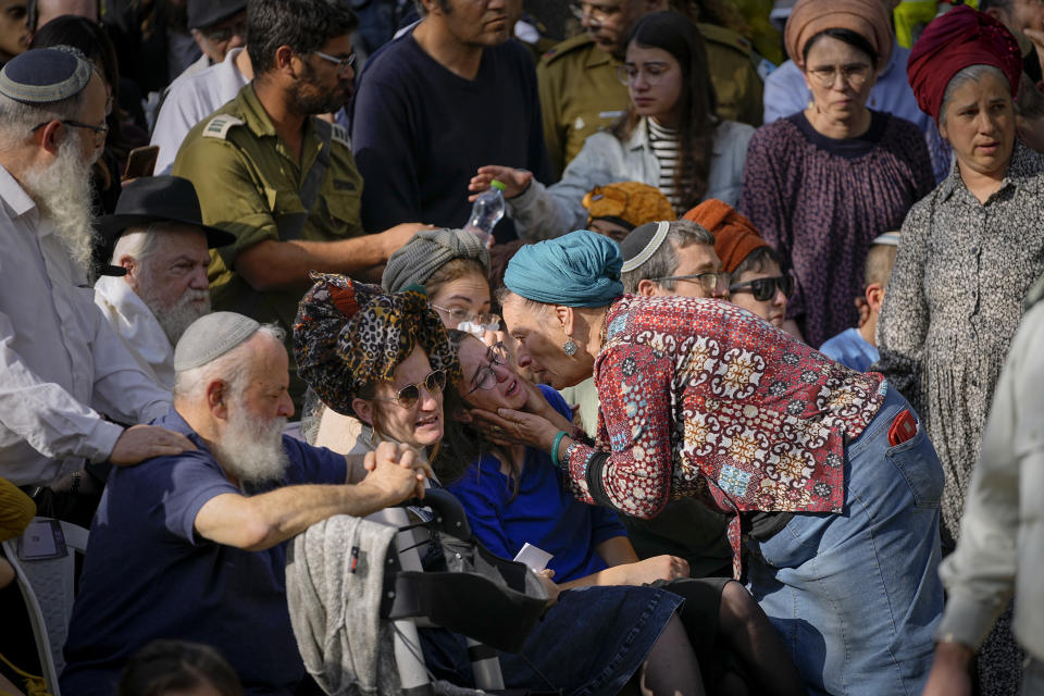 Family and friends of Hillel Yaniv, 21, and Yagel Yaniv, 19, attend their funeral at Israel's national cemetery in Jerusalem, Monday, Feb. 27, 2023. The two Israeli brothers were killed Sunday in the West Bank town of Hawara by a Palestinian gunman who fled the scene. (AP Photo/Ohad Zwigenberg)