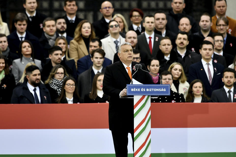 Hungary's right-wing populist prime minister, Viktor Orban addresses thousands of supporters as they gather in Budapest, Hungary, Tuesday, March 15, 2022. The so-called "peace march" was a show of strength by Orban's supporters ahead of national elections scheduled for April 3, while a coalition of six opposition parties also held a rally in the capital. (AP Photo/Anna Szilagyi)