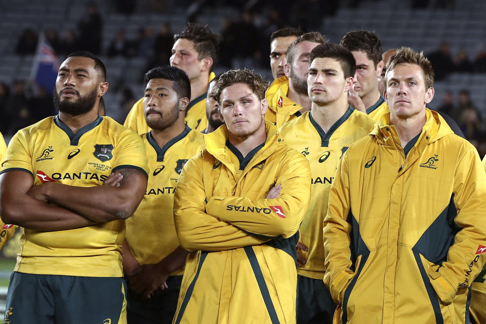 Australia's Michael Hooper, center, with his team look dejected after their loss to New Zealand in the Bledisloe Cup rugby test match at Eden Park in Auckland, New Zealand, Saturday Aug. 25, 2018. (AP Photo/David Rowland)